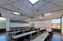 The daylighting strategy combines common skylights and acoustical ceiling tiles in a uniqe sloped ceiling system. - Photo Credit: Stephen Miller