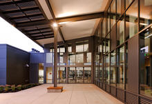 Sliding glass doors between the commons and the covered entry plaza provide flexibility in the building function. - Photo Credit: Stephen Miller