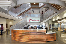 Wood from the existing building was used in finish elements at the reception desk and on the main stair - Photo Credit: Lara Swimmer